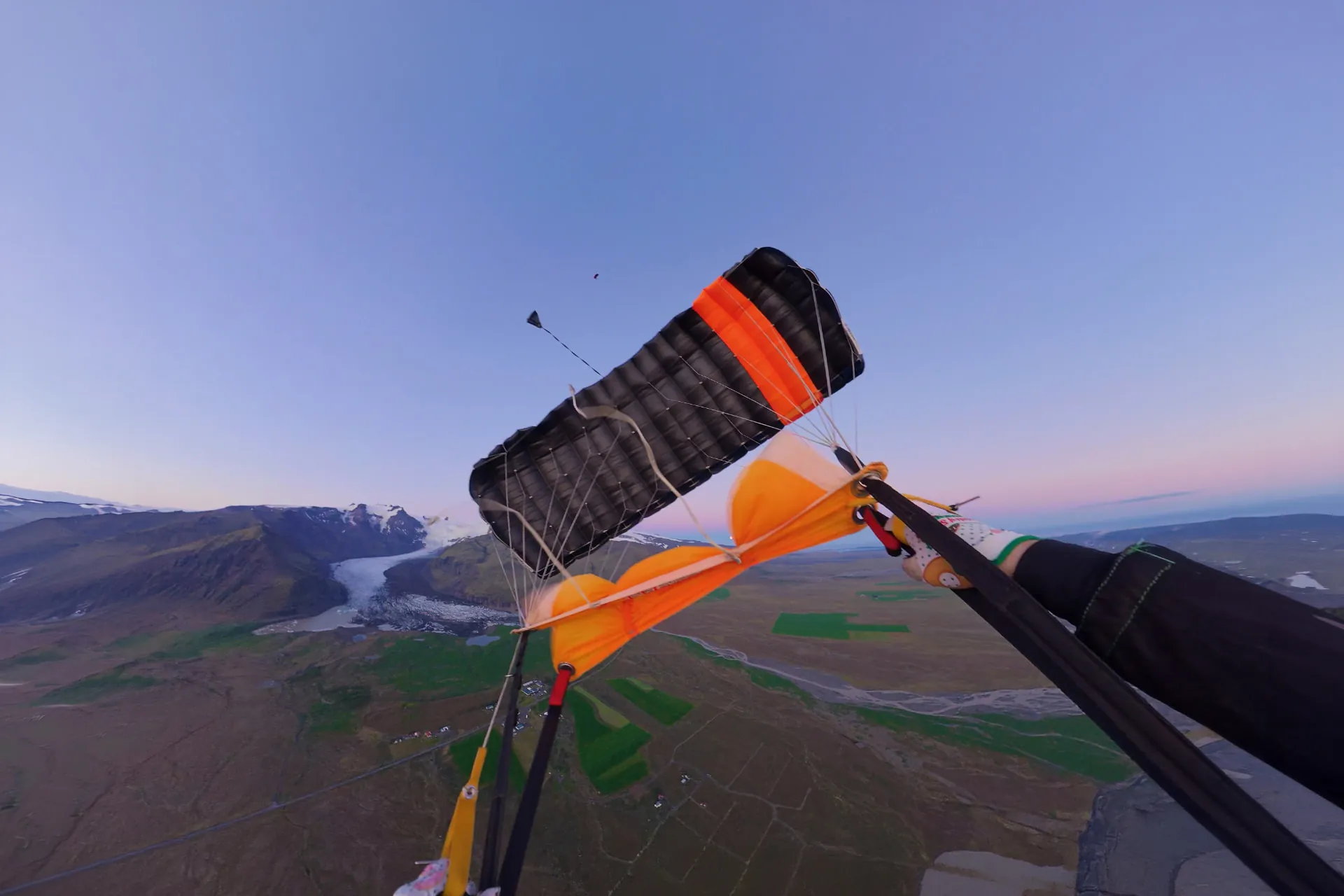 Parachute canopy flying over Iceland at dusk